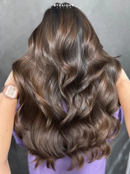 Layers of luxury and waves of confidence. This style features long layers and a rich color melt for a truly glamorous result.