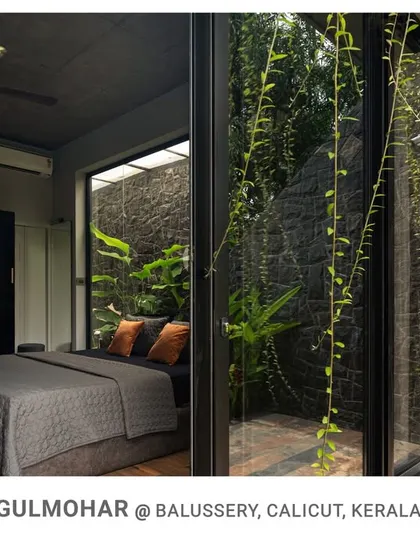 This bedroom at Gulmohar is designed with a private, glass-enclosed courtyard, allowing residents to enjoy a personal garden view right from their bed.