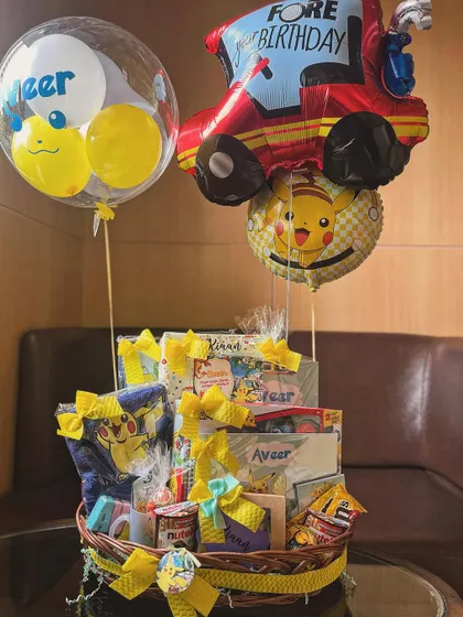 This Pokémon-themed birthday hamper for a little boy named Aveer was so much fun to create. It's a grand basket filled with toys, treats, and personalized balloons.