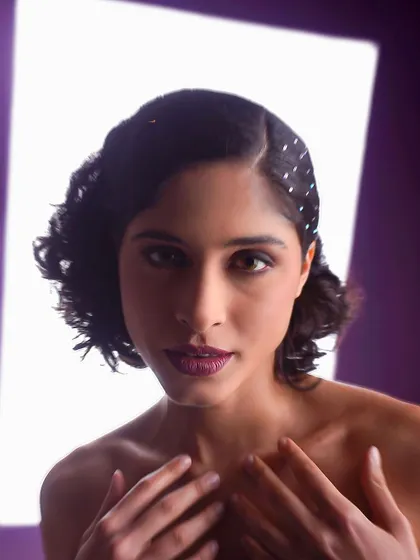 Using a white panel to bounce and shape the light, creating a frame-within-a-frame effect for this retro-styled headshot.