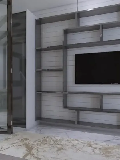 A custom-built, geometric shelving unit surrounding the TV, serving as both storage and a major design feature.