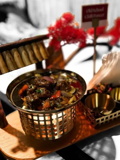 A close-up of our Old School Chilli Paneer, showcasing the vibrant colors of the peppers and onions mixed with soft paneer. It's a perfect appetizer to spice up your event.