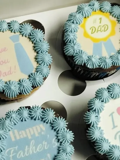 A sweet and simple way to celebrate Dad. This set of Father's Day cupcakes features light blue buttercream frosting and a variety of heartfelt messages and designs.