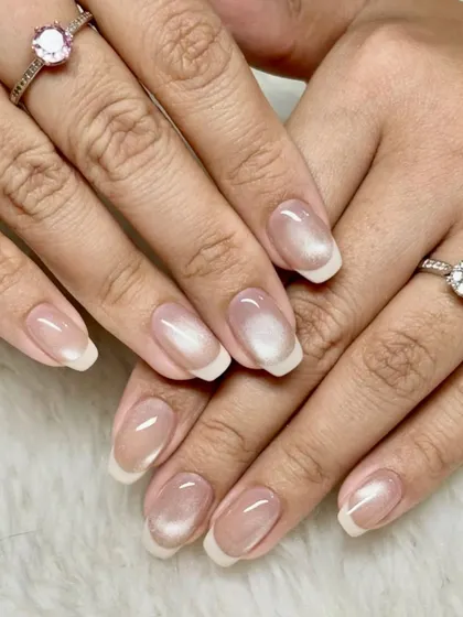 Quiet luxury, loud confidence. This is a perfect example of a glazed donut or chrome finish on a classic French manicure, giving it a modern and trendy update.