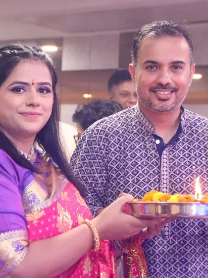 A couple holding a traditional puja thali during a ceremony. We document the cultural and religious rituals that are part of your family celebration.