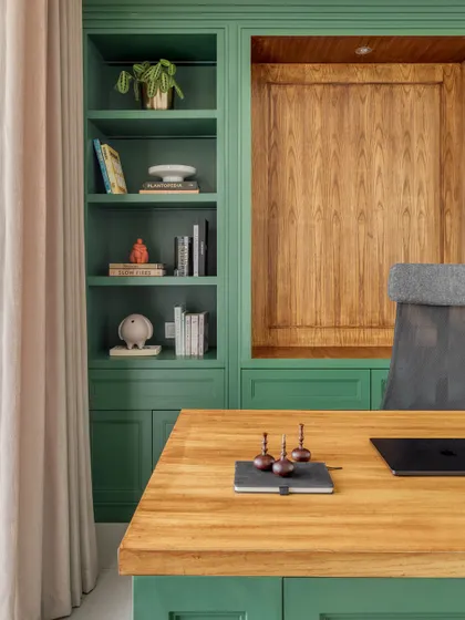 A detail of the custom-built shelving in the study. The shelves are styled with books and objects that reflect the clients' personalities, making the space feel personal and curated.