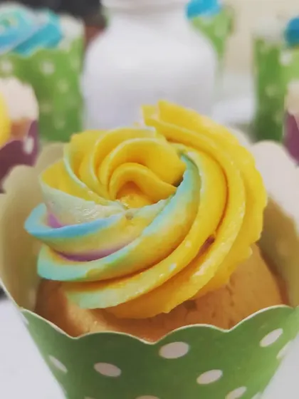 Colorful rainbow-swirl cupcakes served at a birthday celebration. These sweet treats not only taste delicious but also add a pop of color to the dessert table, perfectly matching a fun and festive party theme.