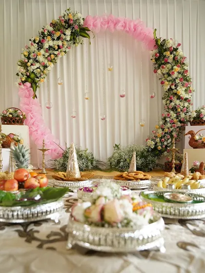 Another variation of the floral ring backdrop, this time with a pink fabric accent. This setup was for a naming ceremony, with traditional silver plates of fruits and sweets placed in front.