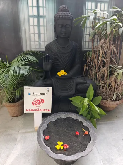 A straight-on view of the 4-foot black marble Buddha statue, highlighting its grounding and peaceful presence. This piece is carved from a single block of stone.