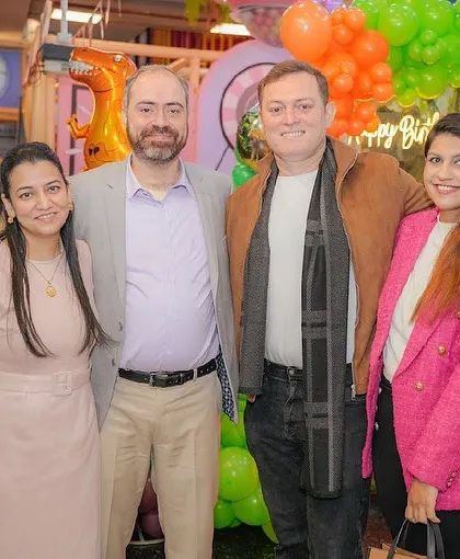 A group of adult guests enjoying the celebration and posing for a photo.