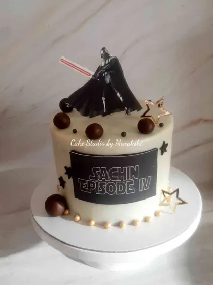 A Star Wars themed cake featuring the formidable Darth Vader. A simple yet striking design for a fan of the epic saga.