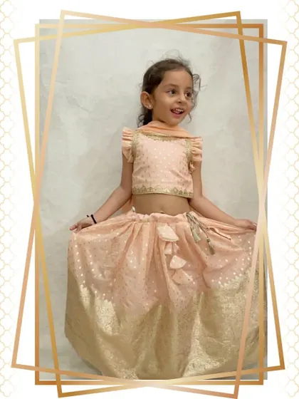 A full shot of the happy client in her periwinkle lehenga, showing how easy it is to move and sit in.