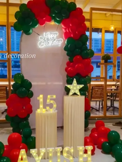 A wide shot of the red and green themed 15th birthday party setup.