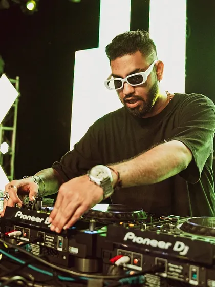 In the zone. This is where the magic happens, behind the decks, focused on the mix. Every track is chosen to build the energy and create a seamless journey for the dancefloor.