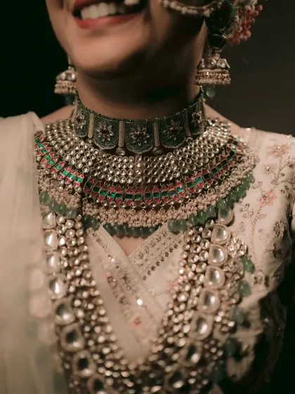 A close-up on the bride's magnificent, multi-layered polki and kundan necklace.