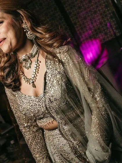 A beautiful candid of the bride on the dance floor, her smile illuminated by the party lights.