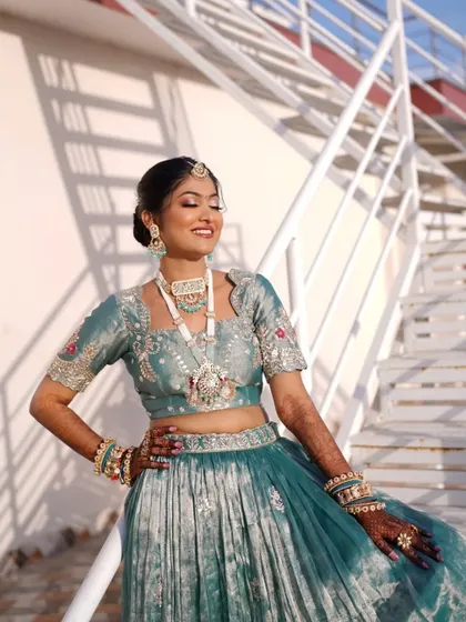 The sunlight catching her smile and the beautiful details of her outfit and makeup.