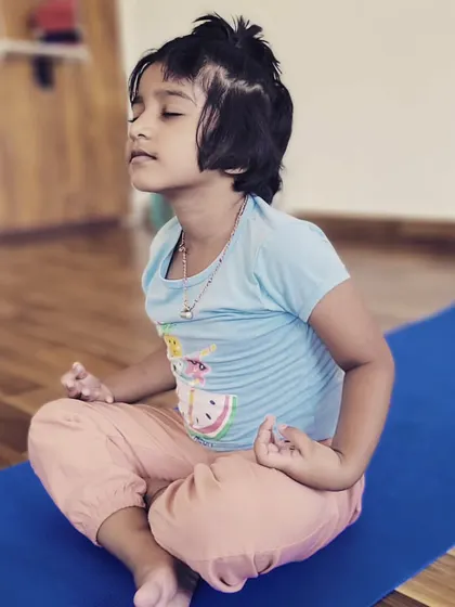 A moment of calm and focus. This little one is practicing a simple meditation, learning to find stillness from a young age.