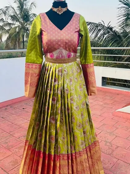 A full view of the stunning green and pink silk gown, available for rent.