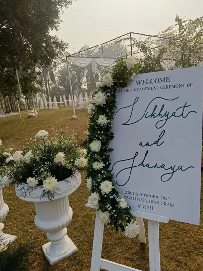 The welcome sign set against the backdrop of the outdoor venue. It serves as a beautiful focal point and a great spot for guests to take photos as they arrive.