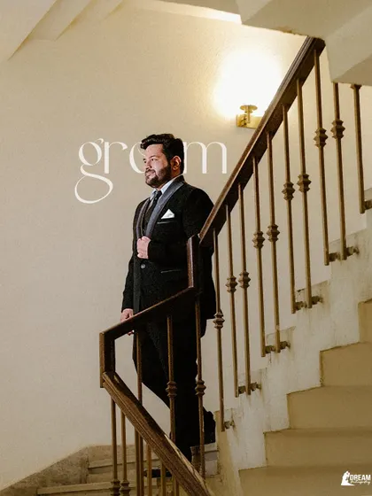 A classic portrait of groom Nikhil on the staircase, looking dapper and ready for his reception.