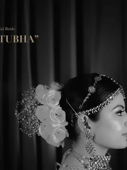 A moody, black and white bridal portrait that emphasizes emotion and elegance. This fine-art photography style focuses on profile shots, delicate jewelry, and floral hair accessories to create a truly artistic memory.