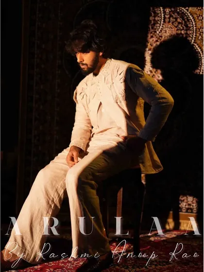 The final look is understated yet incredibly detailed. The tonal appliqué work on the linen jacket creates a sophisticated and artistic effect.