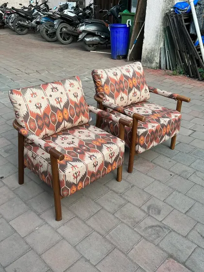 A clear shot showing the pattern and comfortable cushions of the chairs.