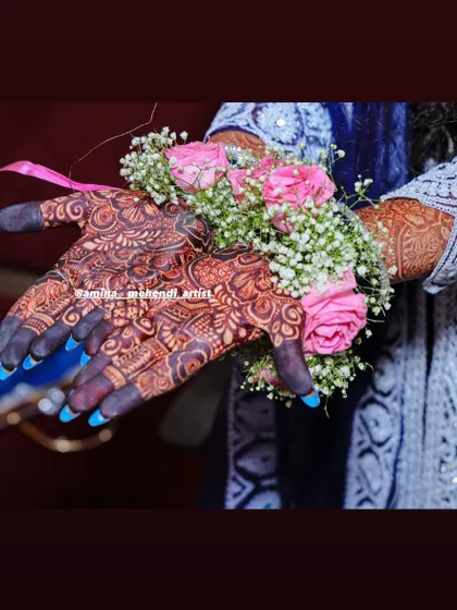 Another angle of the stained mehendi with floral jewelry, showing the deep color on the palms.