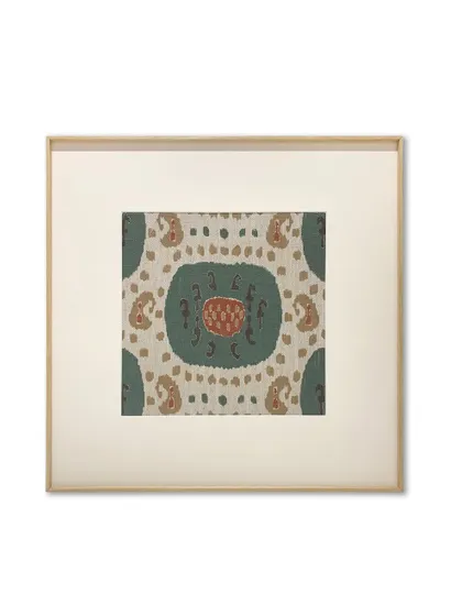 A single, beautiful section of a rug, framed with a wide, off-white mat and a thin metal frame with a wood-like finish. This classic presentation elevates the textile, making it feel like a fine art print.