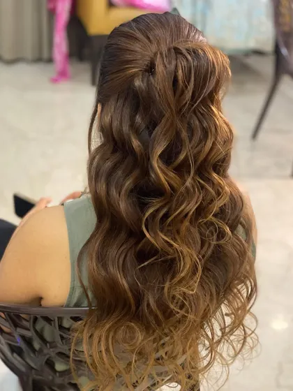 I love creating these messy, textured waves. This half-tie look is perfect for a casual party, with extensions giving the hair that extra oomph.