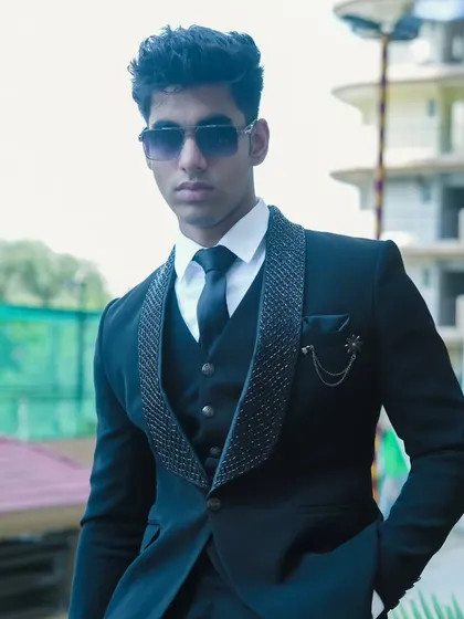 A full view of the black three-piece suit with a textured lapel, a very popular choice for its modern and subtle design.