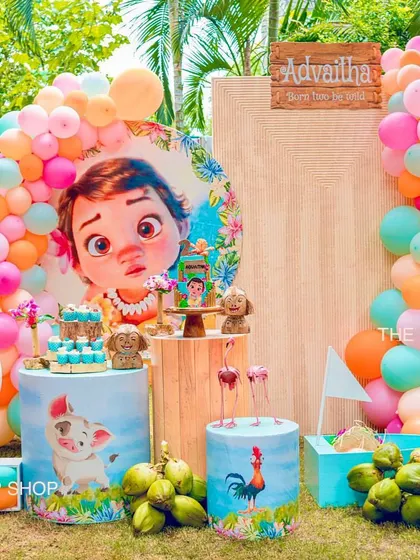 This wide shot of the Moana birthday setup highlights the scale of our decor, including the large balloon arch and custom props that transform an outdoor space into a tropical paradise.