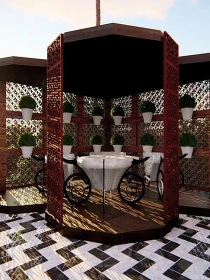 A closer look at the unique gazebo we designed for our Tilak Nagar site. The structure provides an intimate dining space, surrounded by decorative screens and planters, all set upon a bold black-and-white patterned floor.