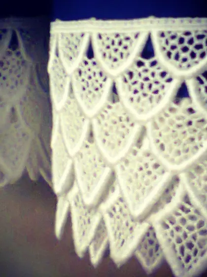 A close-up of beautiful white scalloped lace. I love sourcing unique materials like this to add texture and a delicate finish to dresses, blouses, and dupattas.