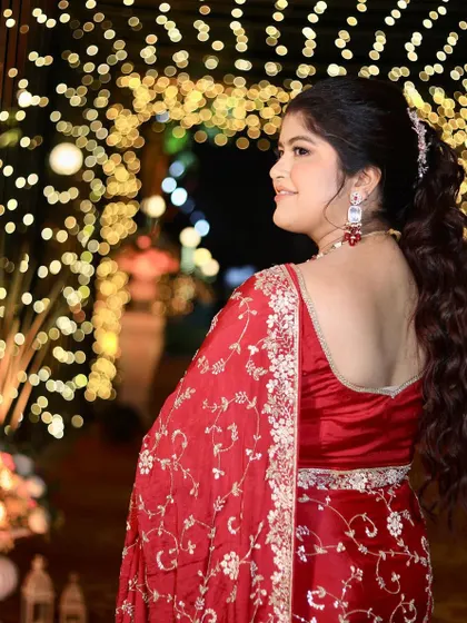 A view of the beautiful ponytail hairstyle and the glowing makeup from the back. This look is perfect for a reception, keeping the hair off her face while still looking elegant.