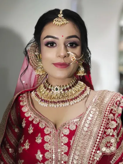 A close-up portrait of a lovely bride. I used soft purple and pink tones on her eyes to add a touch of modern color to her traditional red outfit.