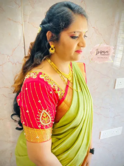 A side profile showing the soft curls and elegant makeup for this housewarming look.