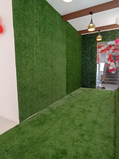 This hallway was transformed into an immersive green passage. I installed artificial grass on the floor and up the walls, creating a continuous, vibrant path that guides visitors.