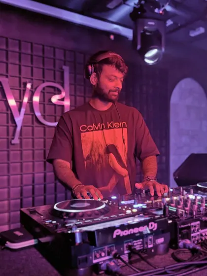 Focused on the mix at Level. The purple lighting and sound-paneled walls create an intimate but intense clubbing environment.