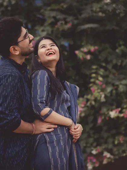 A joyful, upward-looking pose from a pre-wedding shoot, capturing a feeling of optimism and happiness.
