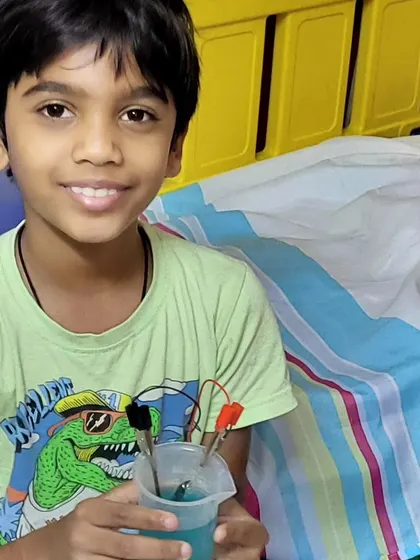 A happy and proud student with his successful chemistry experiment. The smile of accomplishment is the best reward.