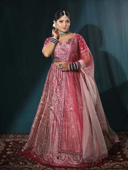 Another angle of the pink bridal lehenga, showing the detail on the blouse and the delicate net dupatta.