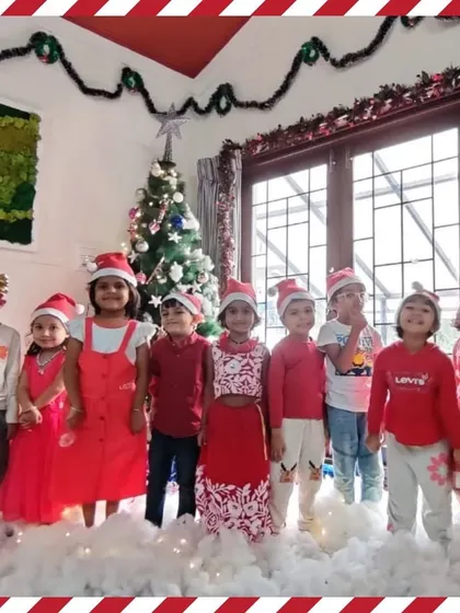 A group of children in their festive red outfits pose for a Christmas photo.