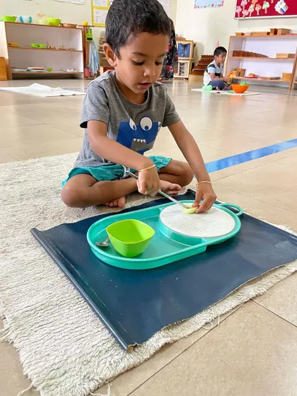 A series of images showing children engaged in food preparation. Whether it's cutting, peeling, or spooning, these activities are fundamental for developing the fine motor skills and concentration needed for writing and other complex tasks.