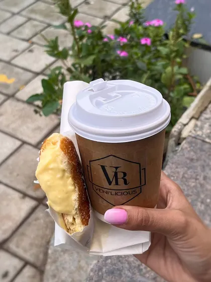 Your daily fix. A hot cup of coffee and a freshly made Custard Berliner is the perfect breakfast run combo.