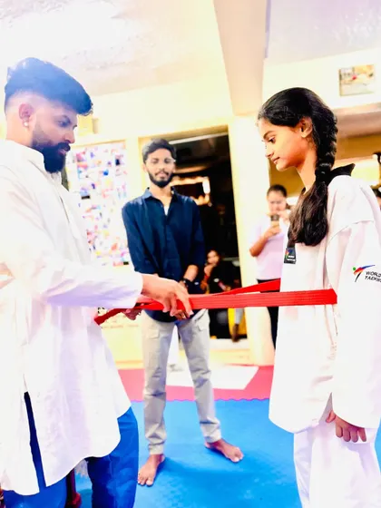Presenting a red belt to a senior student.