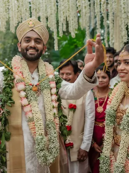 A happy moment during the varmala exchange. We focus on the couple's expressions and the joyful atmosphere of the ceremony.