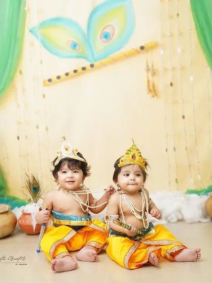 Two little Krishnas sharing a sweet moment. Photographing twins is always a special joy, and this traditional theme makes it even more memorable.