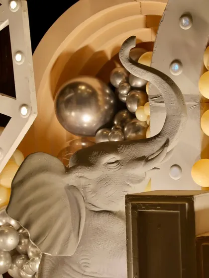 A close-up of a beautifully sculpted elephant prop, a key element in this sophisticated jungle-themed birthday party.